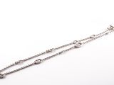 a close up of a pair of silver chain bracelets on a white background