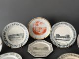 many plates with different designs on them on a table