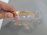 a person that is holding a glass cup in their hand