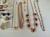 many different necklaces and bracelets on the table