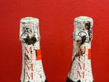 two bottles of wine that are sitting on a table