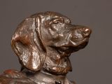 a statue of a dog that is sitting on a table