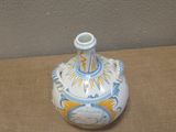 a small blue and white vase sitting on a table