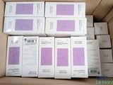 several boxes of white and purple paper are stacked on top of each other