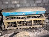a blue bench sitting in the middle of a dirty room