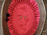 a hat with a rosette on it sitting on a chair