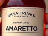someone is holding a bottle of amarretto in their hand
