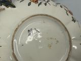 a close up of a plate with a flower design on it