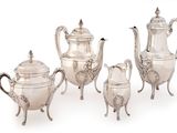 three pieces of silver tea and coffee set on a white background