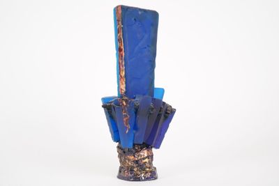 a blue vase that has some kind of rock inside of it