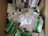 a cardboard box full of medicine and other medical supplies