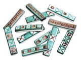several pieces of green and brown polymer beads on a white surface