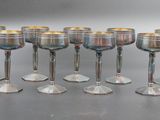 many wine glasses lined up in a row on the table