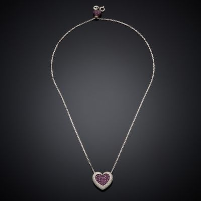 a necklace with a heart shaped pendant on a chain