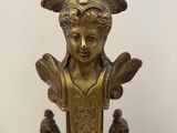 l'image d'une statue de femme à la tête fleurie sur un socle