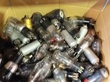 a cardboard box full of empty bottles and other items