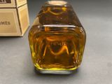 a bottle of honey sitting on a table next to a box