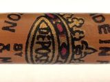 the cigar is sitting on a white surface with a white background