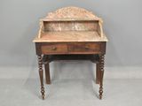 a small desk with a marble top and wooden legs