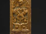 an old wooden block with a carving of a man on a horse