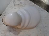 a white vase sitting on top of a marble table