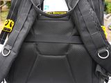 a black backpack with a yellow tag attached to it