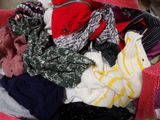 a pile of clothes in a basket on the floor