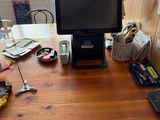 a desk with a monitor, keyboard, mouse, and other items on it