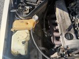 a car engine with the hood open on the street
