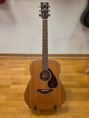 a guitar that is sitting on the floor in the room
