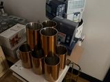 a table with a bunch of cups and boxes on it