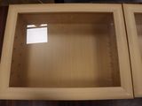 two wooden cabinets with glass doors on top of a table