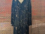 a dress on a mannequin stand in front of a wall