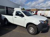 a picture of a white pick up truck parked in front of a building