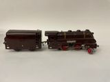 Deux petits trains sont posés côte à côte sur une surface blanche