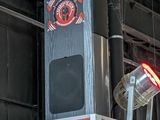 two speakers that are on top of a red wall