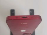a close up of a red cell phone on a stand