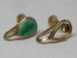 two pairs of gold and green stone earrings on a white surface