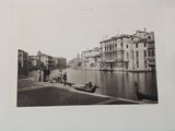 a black and white photo of people on a boat on the water