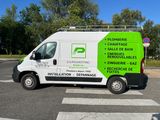a white van that is parked on the side of the road
