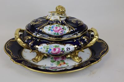 a black and gold plate with a bowl on it