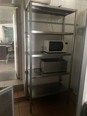 un micro-ondes et un four à micro-ondes posés sur une étagère dans une pièce