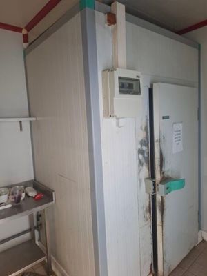 un réfrigérateur dans un coin d'une cuisine en cours de rénovation