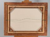 an old wooden easel with a white canvas on top of it