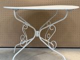 an image of a white iron table with a white table top