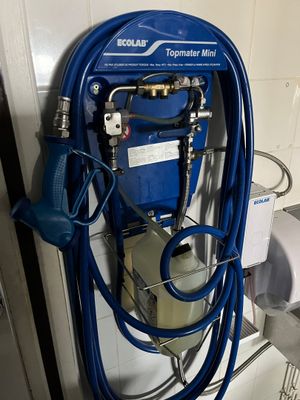 a blue hose attached to a blue machine in a bathroom