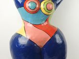 sculpture of a woman in a blue bodysuit with a red and yellow top