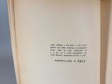 an open book on a table with a pen in it