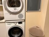 two washers and a dryer in a small room