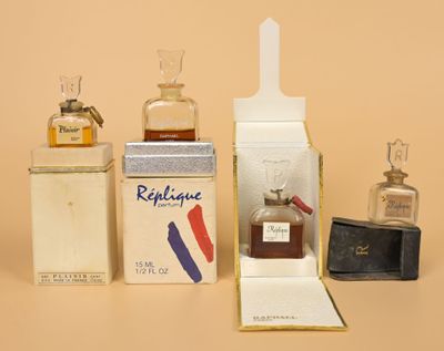 three bottles of perfume sitting next to each other on a table